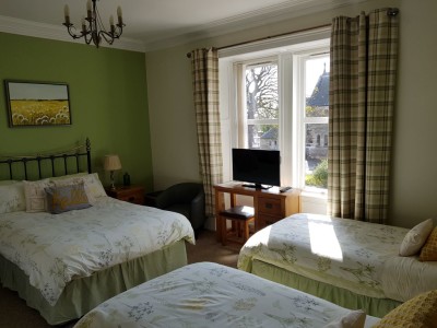Green room, a large family room with one double and two twin beds, en-suite shower room, tv, hairdryer, toiletries , hospitality tray including homemade shortbread